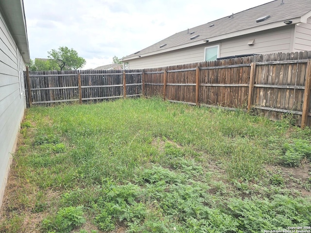 view of yard with a fenced backyard