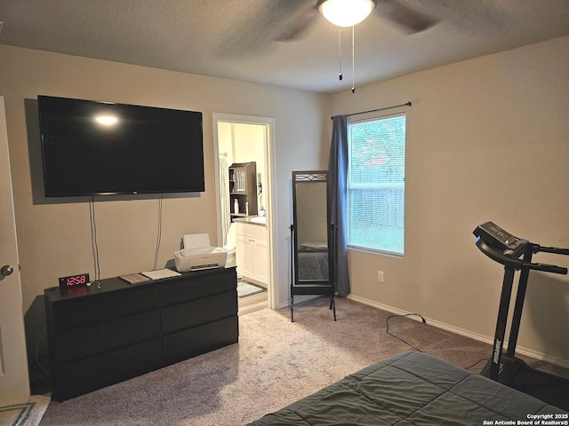 carpeted bedroom featuring baseboards, ceiling fan, and connected bathroom