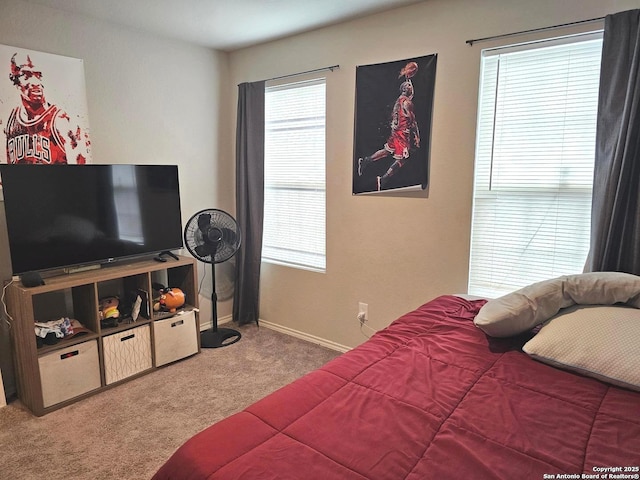 carpeted bedroom with baseboards and multiple windows