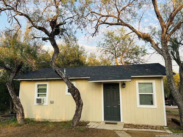 5764 Fm 1628, Adkins, TX 78101 - view of front of house with cooling unit and a shingled roof