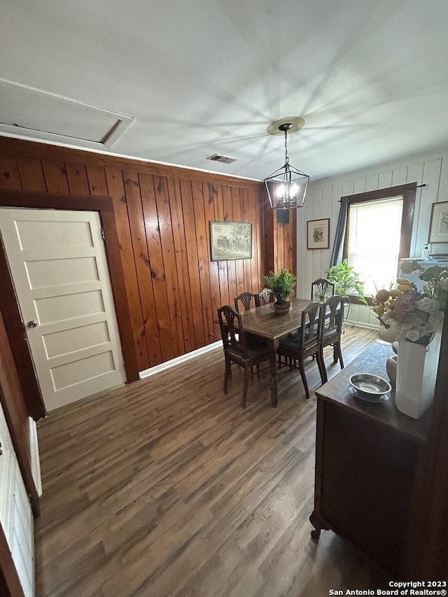 5764 Fm 1628, Adkins, TX 78101 - dining room with visible vents, wooden walls, and wood finished floors