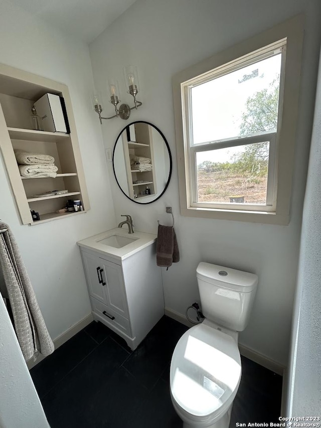 5764 Fm 1628, Adkins, TX 78101 - bathroom with vanity, toilet, baseboards, and tile patterned floors