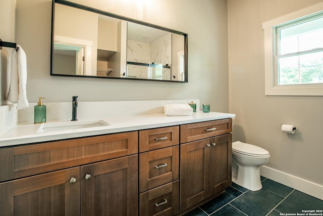 227 Quentin, San Antonio, TX 78201 - bathroom with tile patterned floors, toilet, baseboards, vanity, and a walk in shower