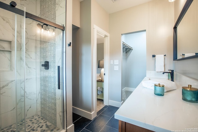 227 Quentin, San Antonio, TX 78201 - bathroom with tile patterned floors, a marble finish shower, vanity, and a walk in closet
