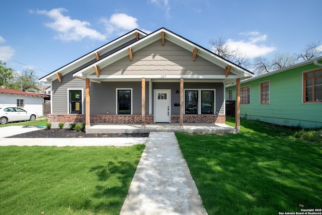227 Quentin, San Antonio, TX 78201 - bungalow-style house featuring brick siding, covered porch, and a front yard