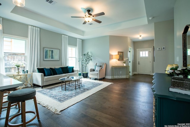 227 Quentin, San Antonio, TX 78201 - living area with dark wood-style flooring, baseboards, visible vents, a ceiling fan, and a raised ceiling