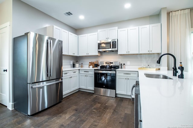227 Quentin, San Antonio, TX 78201 - kitchen featuring light countertops, stainless steel appliances, dark wood-type flooring, and a sink