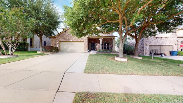 view of property hidden behind natural elements featuring concrete driveway, brick siding, a garage, and a front yard
