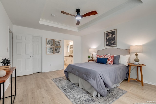 8934 Oakwood, San Antonio, TX 78254 - bedroom with crown molding, ensuite bathroom, light wood-type flooring, a raised ceiling, and baseboards