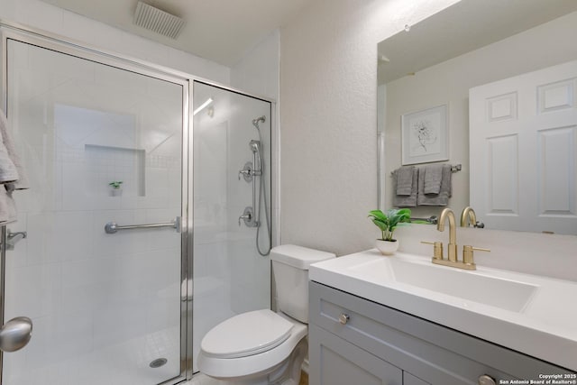 8934 Oakwood, San Antonio, TX 78254 - bathroom featuring a shower stall, toilet, vanity, and visible vents