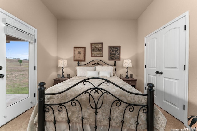 carpeted bedroom featuring a closet and access to exterior