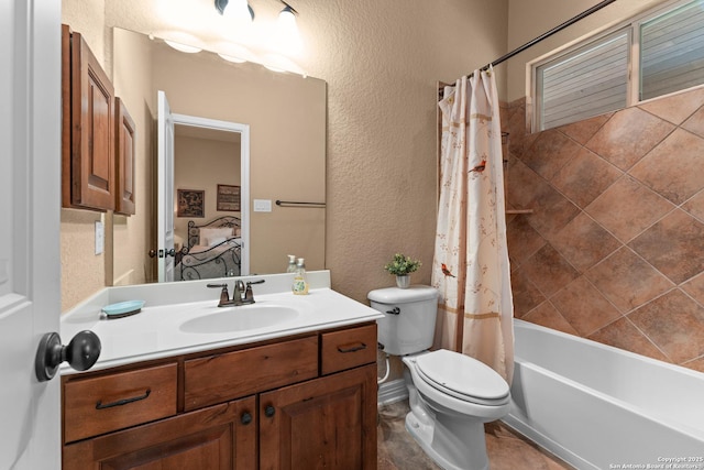 bathroom with toilet, a textured wall, shower / tub combo, and vanity