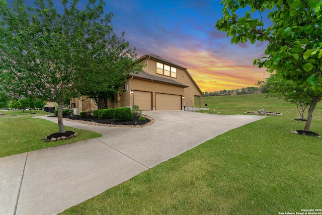 view of front facade featuring stucco siding, concrete driveway, a front yard, and an attached garage