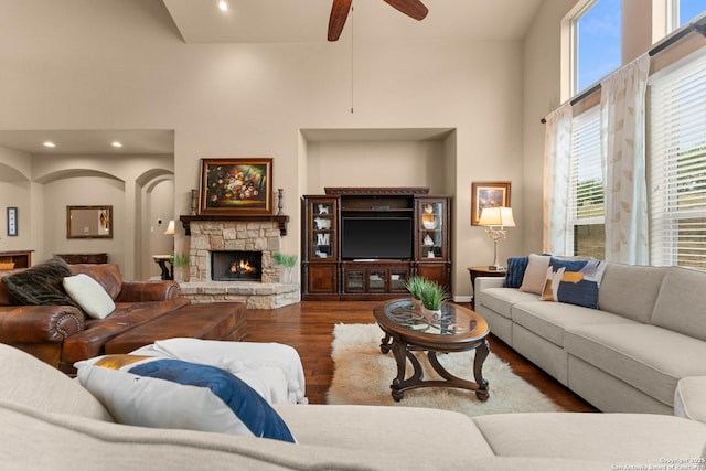 living room with ceiling fan, wood finished floors, a healthy amount of sunlight, and a fireplace