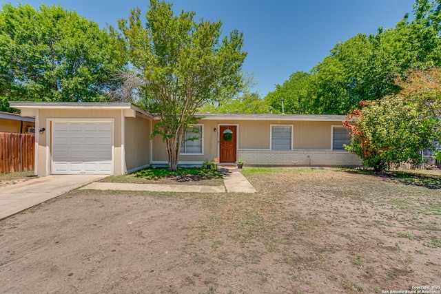 5011 Village Lawn, San Antonio, TX 78218 - ranch-style house with concrete driveway, an attached garage, fence, and brick siding