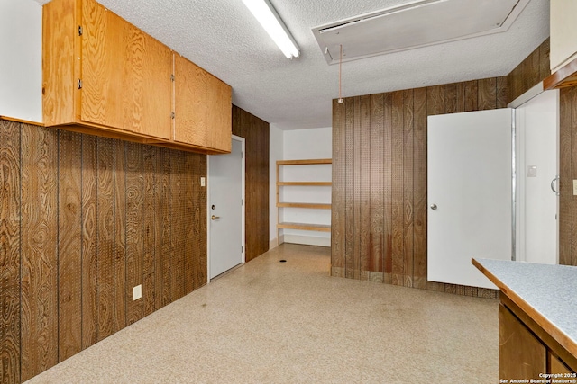 interior space featuring attic access and a textured ceiling