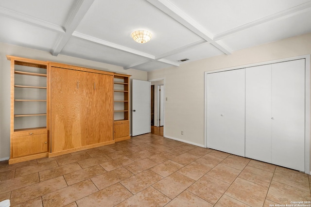 unfurnished bedroom featuring beamed ceiling, a closet, baseboards, and coffered ceiling