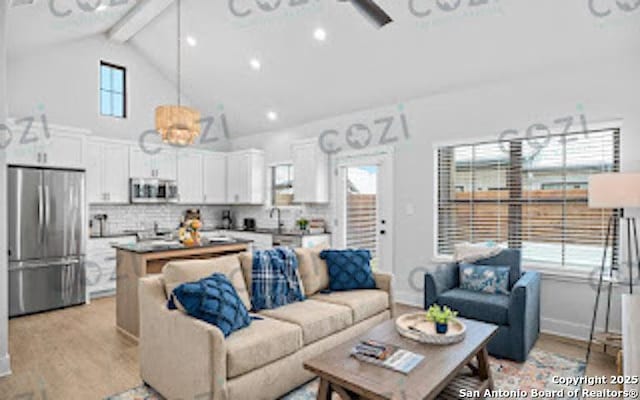 930 S Eagle St Unit 104, Fredericksburg, TX 78624 - living area featuring beamed ceiling, light wood-style flooring, baseboards, and high vaulted ceiling