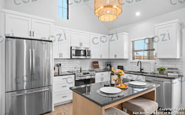 930 S Eagle St Unit 104, Fredericksburg, TX 78624 - kitchen featuring stainless steel appliances, decorative backsplash, a breakfast bar area, and a healthy amount of sunlight