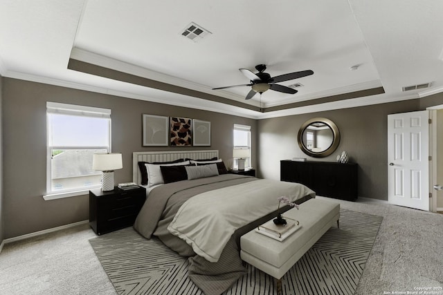 bedroom with visible vents, ornamental molding, and a raised ceiling