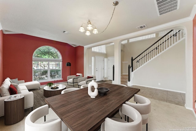dining room featuring a chandelier, visible vents, and stairs