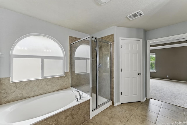 full bathroom with a garden tub, visible vents, tile patterned flooring, and a shower stall