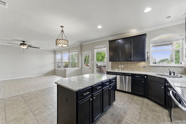 kitchen featuring crown molding, appliances with stainless steel finishes, ceiling fan, and light tile patterned floors