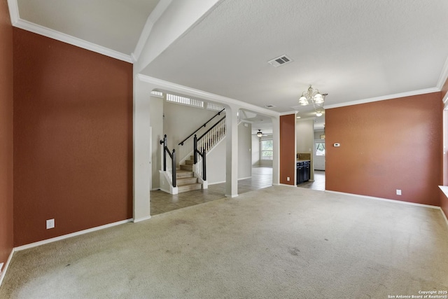 unfurnished living room with stairway, carpet floors, baseboards, ornamental molding, and visible vents