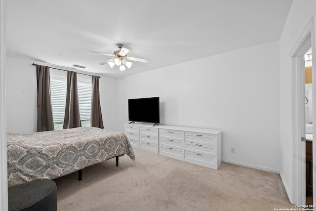 bedroom with light carpet, visible vents, and ceiling fan