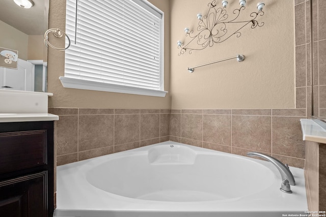 full bath with a garden tub and vanity