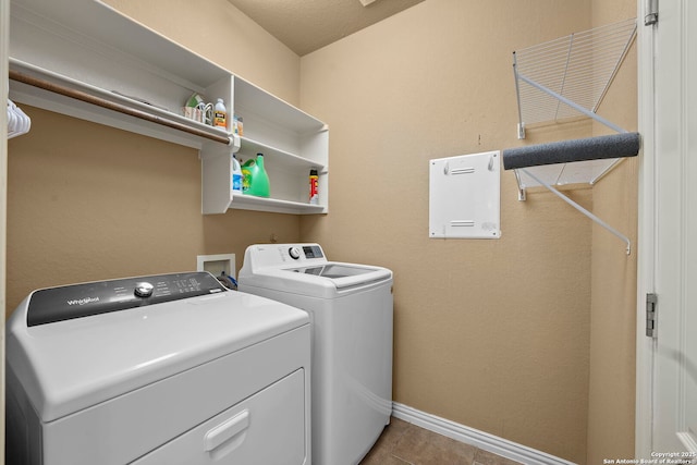 laundry room with baseboards, tile patterned flooring, laundry area, and independent washer and dryer