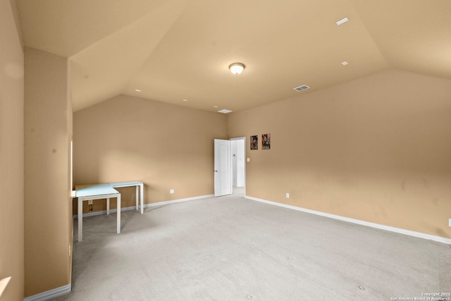 bonus room with lofted ceiling, baseboards, and carpet