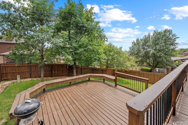 wooden deck featuring a fenced backyard