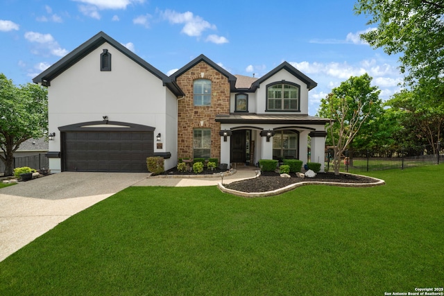 traditional-style house with stucco siding, fence, stone siding, and a front yard