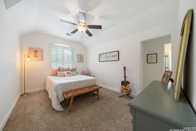 carpeted bedroom with visible vents, vaulted ceiling, baseboards, and ceiling fan