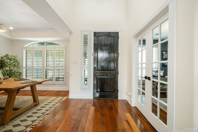 entrance foyer featuring plenty of natural light, french doors, wood finished floors, and ornamental molding