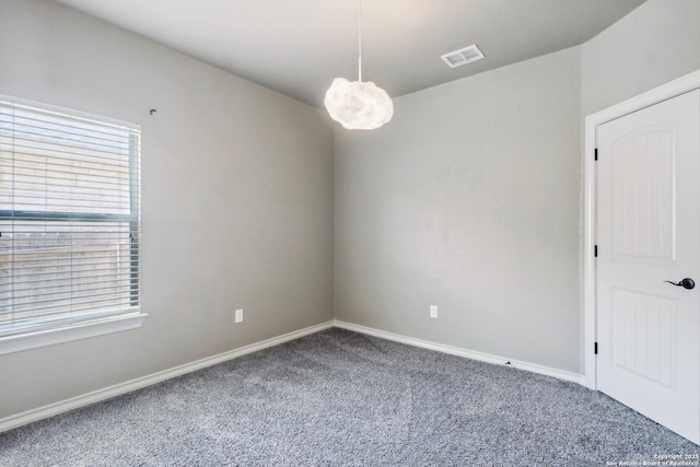 unfurnished room featuring baseboards, carpet flooring, and visible vents
