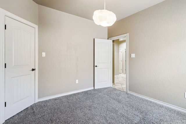 unfurnished bedroom with baseboards and light colored carpet