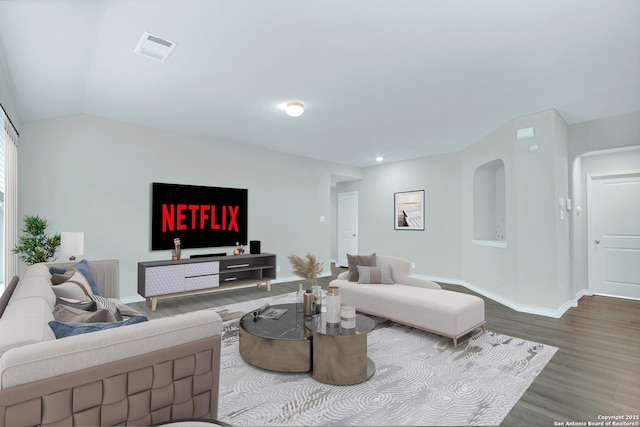living room with recessed lighting, vaulted ceiling, wood finished floors, visible vents, and baseboards