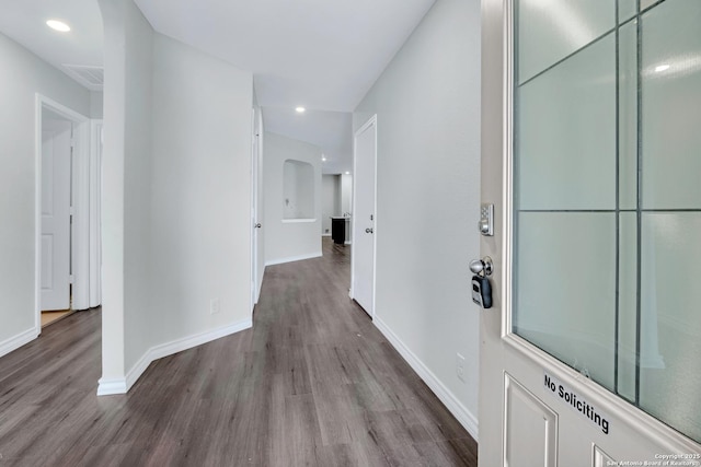 corridor featuring recessed lighting, wood finished floors, and baseboards