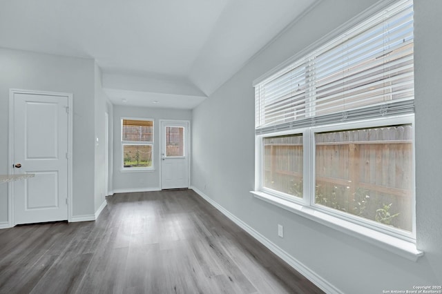 interior space featuring baseboards and wood finished floors