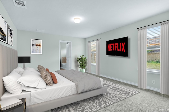 bedroom featuring baseboards, visible vents, carpet flooring, and multiple windows