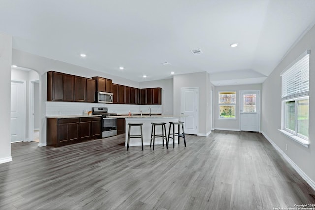 kitchen featuring stainless steel appliances, visible vents, a wealth of natural light, and tasteful backsplash