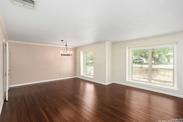 empty room with wood finished floors, a chandelier, visible vents, and plenty of natural light