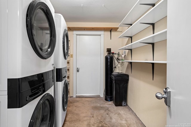 laundry area featuring stacked washer and dryer and laundry area