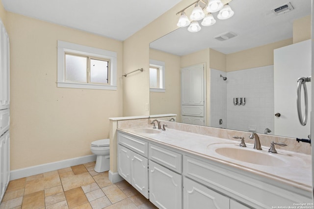 full bathroom with baseboards, visible vents, a sink, and a tile shower