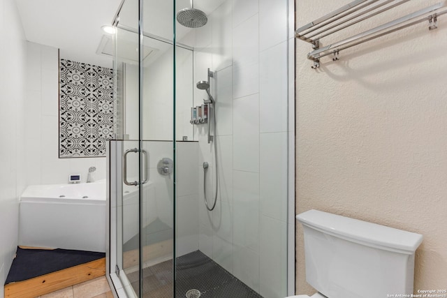 bathroom featuring a shower stall and toilet