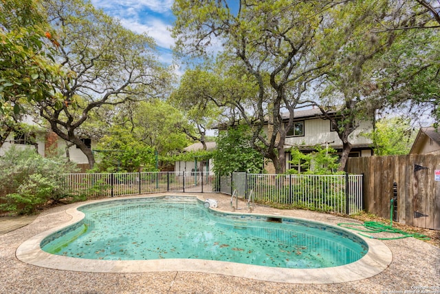view of swimming pool with a fenced in pool and fence