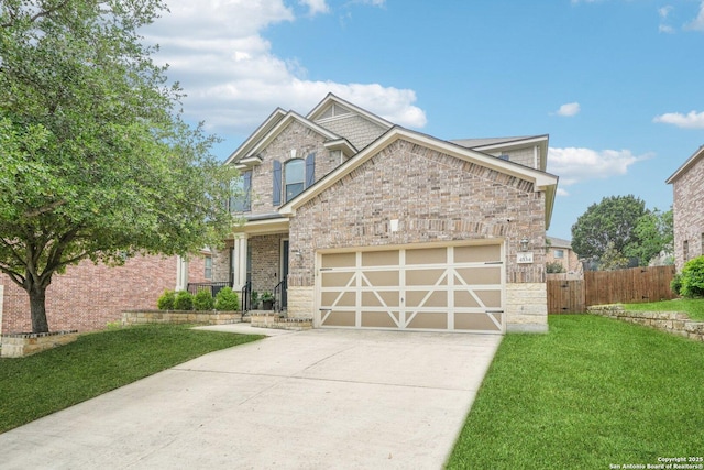 craftsman-style home with fence, an attached garage, driveway, brick siding, and a front yard