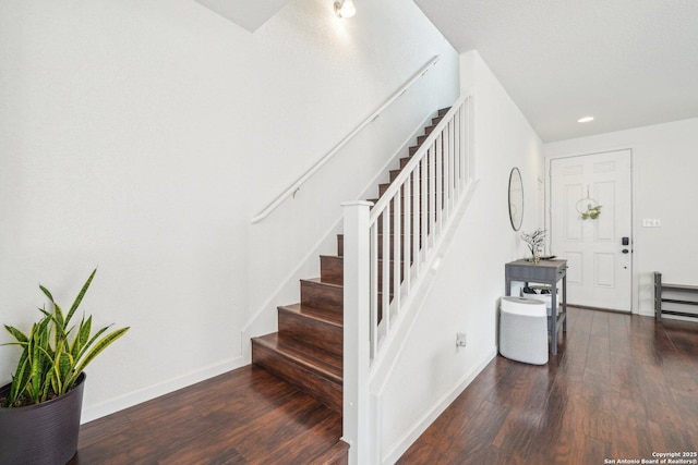stairway featuring baseboards, wood finished floors, and recessed lighting